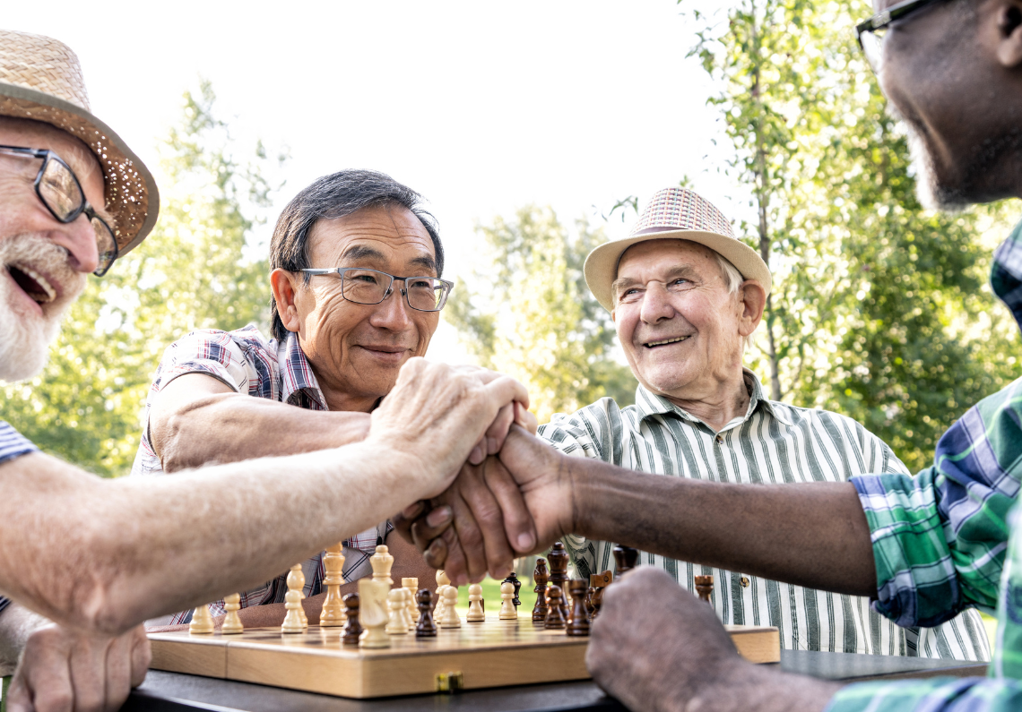 Image of four senior men playing chess