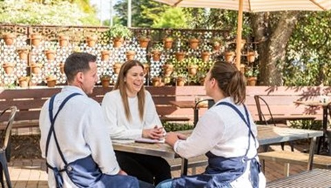 Three people chatting at table