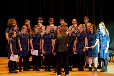 School choir mid performance on the stage