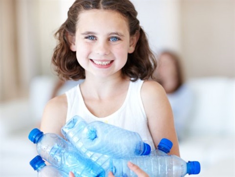 girl holding plastic bottles for recycling